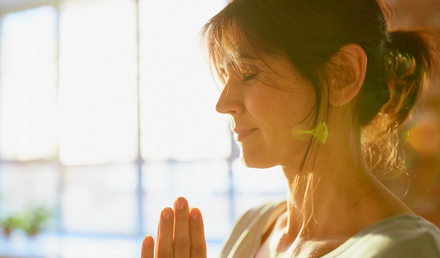 close up of yogi woman meditating at yoga studio